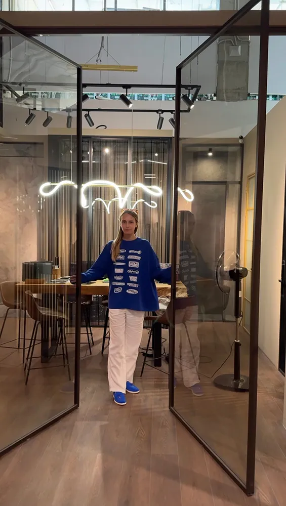 Девушка открывает двери распашной стеклянной перегородки, зонирующей кабинет. Купить, заказать межкомнатные перегородки